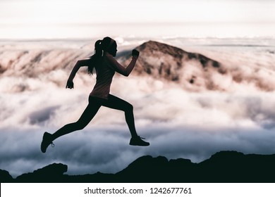 Trail Runner Athlete Silhouette Running In Mountain Summit Background Clouds And Peaks Background. Woman Training Outdoors Active Fit Lifestyle.