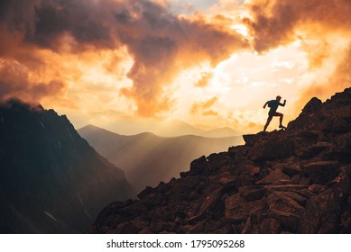 Trail runner in evening summer mountains. sunset sky and edit space in background - Shutterstock ID 1795095268