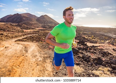Trail runner running man. Sports and fitness concept. Male athlete ultra running in nature mountain path. Active fit sport man in compression clothing on rocks working out cardio training body. - Shutterstock ID 1035889714