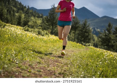 Trail runner running on the high altitude grassland mountain top  