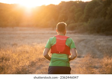 trail runner running at sunset