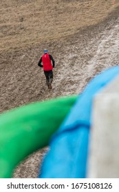 Trail Runner Running Through The Mud To The Finish Line