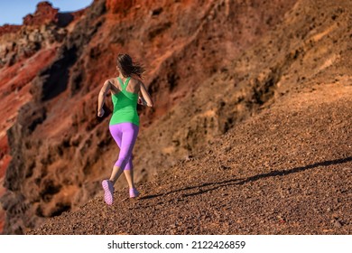 Trail Runner Woman Ultra Running Uphill On Volcano Mountainside. Female Athlete Jogging In Colorful Activewear Training Hiit Workout Woman Training Outdoors.