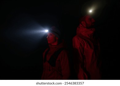 trail runners couple portrait while preparing for an early morning run in the night time with a headlamp - Powered by Shutterstock