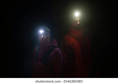 trail runners couple portrait while preparing for an early morning run in the night time with a headlamp - Powered by Shutterstock