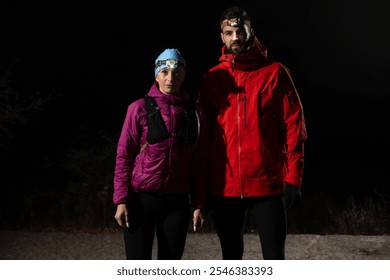 trail runners couple portrait while preparing for an early morning run in the night time with a headlamp - Powered by Shutterstock