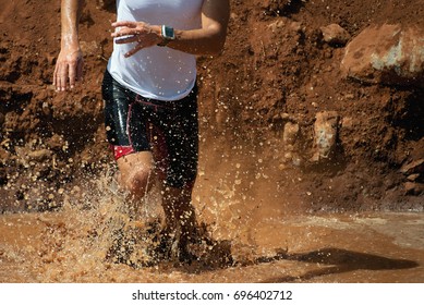 Trail Running Man In The Muddy Terrain