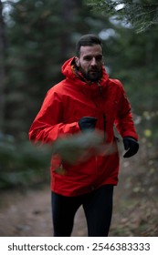 Trail running man runner going up in mountain fores