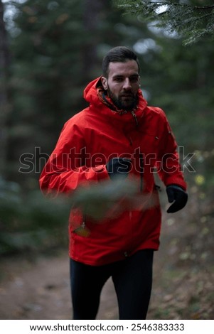 Trail running man runner going up in mountain fores