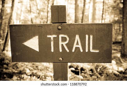 A Trail Sign Made Out Of Wood