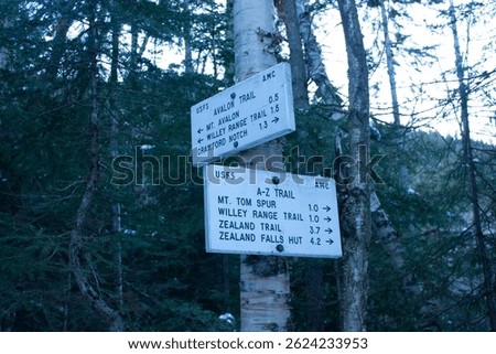 trail signs for mount tom loop in white mountains national forest during the winter
