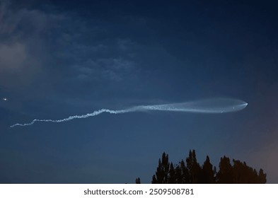 Trail from a space x rocket launching out of cape canaveral, FL - Powered by Shutterstock