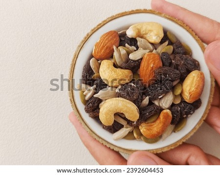 Trail mix or gorp. It is a type of snack mix, typically a combination of granola, dried fruit, nuts, and sometimes candy, developed as a food to be taken along on hikes. 
