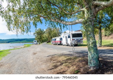 Trailer Caravan In Lake Taupo,New Zealand. People Can Seen Exploring Around It.