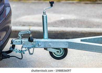 Trailer coupling device for towing a trailer by a passenger car. Cargo transportation and delivery business. Sale, rental and maintenance of trailers. Trailer driving safety concept.  - Shutterstock ID 1988836097
