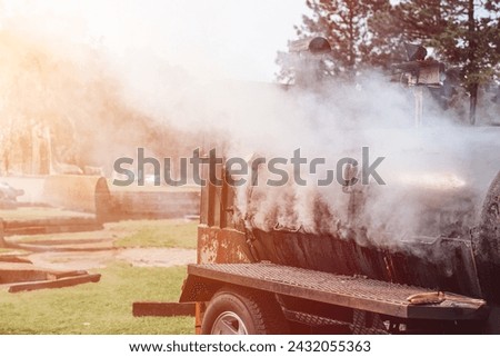 Trailer with a Smoker Grill Parked in a Field for a Relaxing Picnic