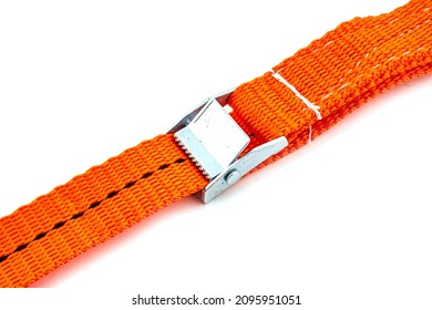 Trailer strop or strap in orange nylon and metal tie isolated over white background. Ratchet straps for cargo load control. Cargo restraint strap