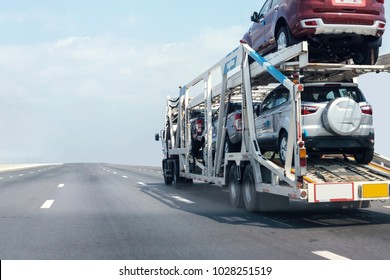 Trailer transport cars on the highway.Truck on highway road container, transportation concept.,import,export logistic industrial Transporting Land transport on the expressway.soft focus of cars