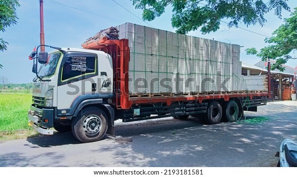 a trailer truck carrying stone hebel light brick\
block \
on a highway, slawi Tegal, central Java, Indonesia, 03\
September 2021