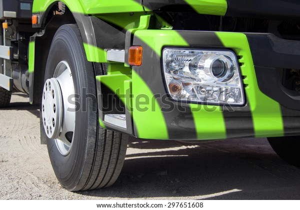 Trailer truck, photography truck, heavy freight,\
transportation of large cargoes, modern truck, truck cab, bright\
paint, horizontal image, the wheel of the truck, the optical lamp\
on the truck.