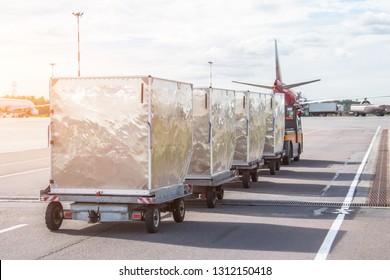 Trailers With Containers Of Onboard Aviation Food For Loading Into A Passenger Airplane.