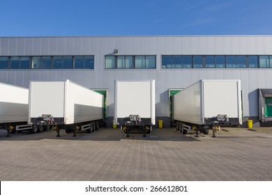 Trailers at docking stations of a distribution center waiting to be loaded