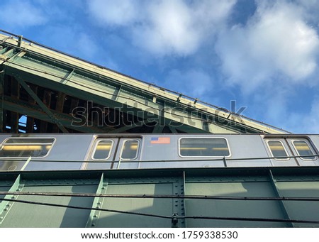 Train above head against a cloudy blue sky in mount Vernon New York