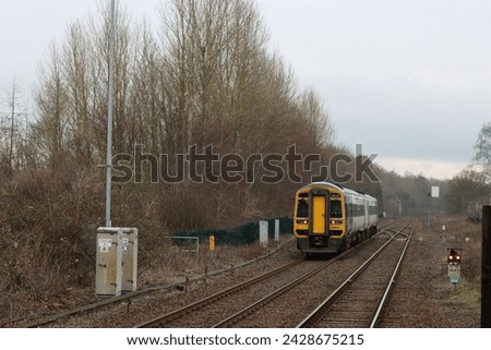 Train approaching a quiet countryside station