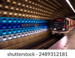 Train arives at Namesti Miru metro station, decorated with modern coloured aluminium panels, in Prague, capital of Czech Republic