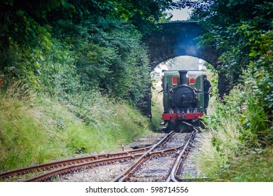 Train Is Arriving To The Station Douglas City, Isle Of Man. Arriving Train Goes By Rail. Steam Train Arriving At The Railway Trains Station Douglas City,Isle Of Man. Steam Locomotive At Trains Station