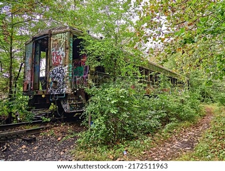Train Car abandon with graffiti and isolated on the Delaware river Canal towpath in Lambertville, NJ by New Hope Pa. USA. Release attached.