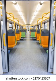 Train Car Inside View With Bright Multi-colored Seats. Railway Carriage. Modern Design. Perspective