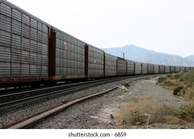train cars curving around a mountain track