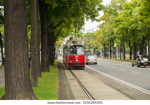 A train and\
cars  on Vienna street,\
Austria