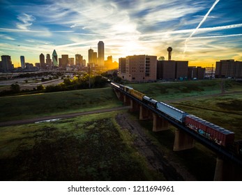 Train Crossing Trestles Heading Towards Dallas , Texas - Sunset Sunrise Aerial Drone View In The North Texas City Skyline Cityscape Golden Hour