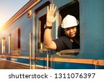 Train driver checking engine of train and gesture the hand to already from the station