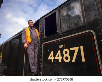 Train Driver Climbs On Board Steam Locomotive At Grosmont Station,on The North Yorkshire Moors Railway,Yorkshire,UK.taken 12/04/2015