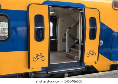 Train at Dutch railway platform with open doors