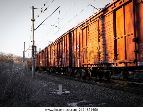 Train freight cars, railroad at dawn, first snow on\
rails and trees