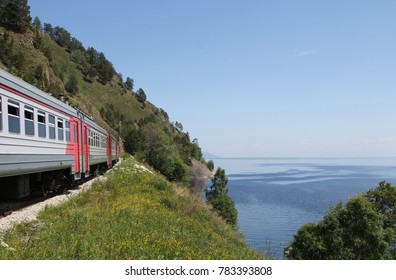 Train Goes By Rail Along The Baikal Lake.