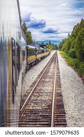 Train Going On A Railroad Track To Denali National Park Alaska