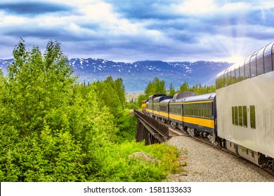 Train Going On A Railroad Track To Denali National Park Alaska