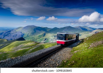 Train going up to the summit of mount Snowdon in Wales UK