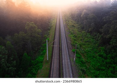 Train Journey Through the Misty Woods: Aerial Perspective at Sunrise - Powered by Shutterstock