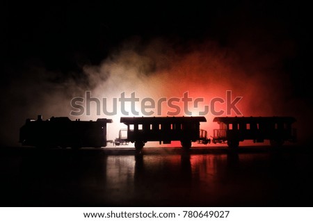 Train moving in fog. Ancient steam locomotive in night. Night train moving on railroad. orange fire background. Horror mystical scene