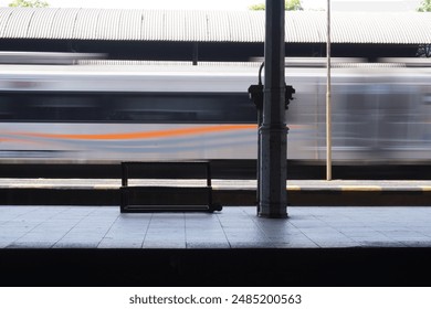 A train is moving on the tracks in the morning at a deserted station in Indonesia - Powered by Shutterstock