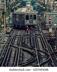 Train on elevated tracks within buildings at the Loop, Chicago City Center - Dark Cross Processing Artistic Effect - Chicago, Illinois, USA