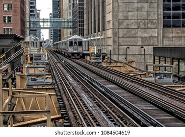 Train on elevated tracks within buildings at the Loop, Chicago City Center - Dark Deep Tonal Artistic Effect - Chicago, Illinois, USA