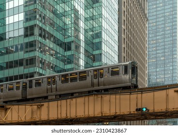 Train on elevated tracks within buildings at the Loop, Glass and Steel bridge between buildings, Chicago City Center, Chicago, Illinois, USA