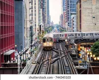 Train on elevated tracks within buildings at the Loop, Glass and Steel bridge between buildings - Chicago City Center - Chicago, Illinois, USA - Powered by Shutterstock